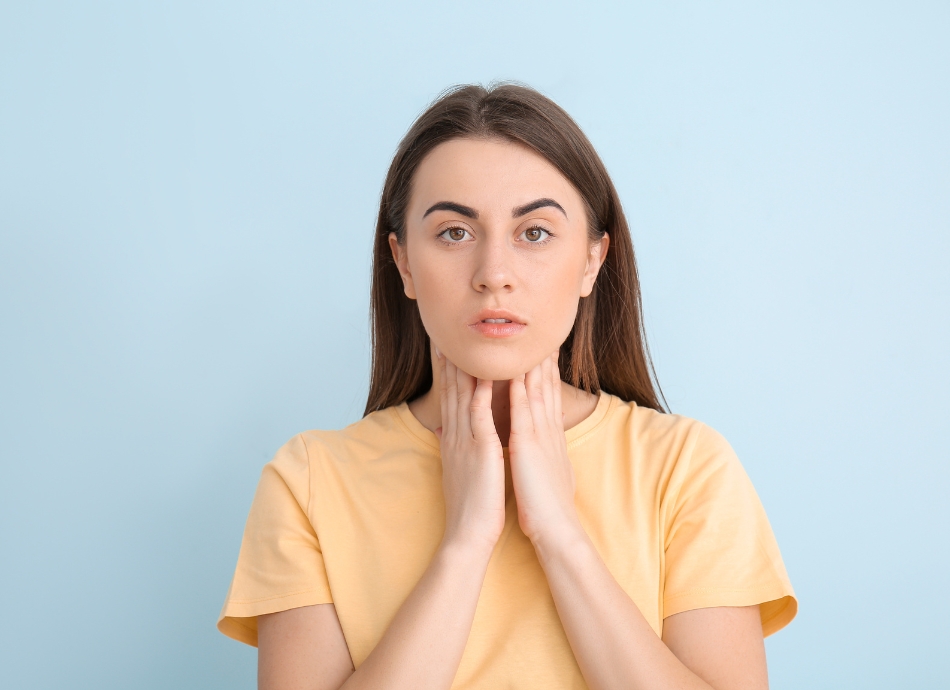 Young woman feeling lump in neck