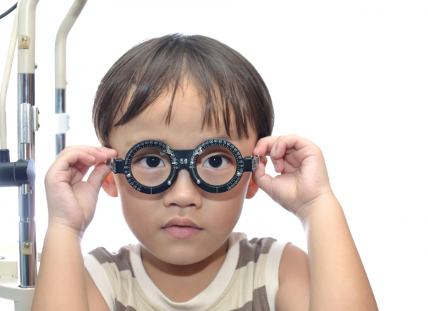 Child getting eye test at optometrist