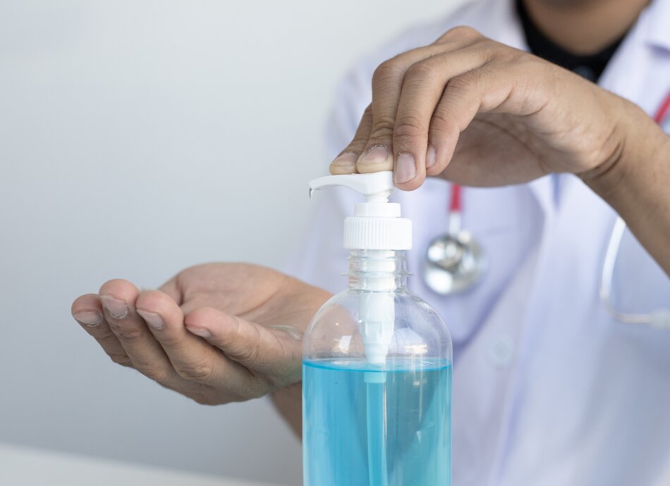 Health professional using hand sanitiser