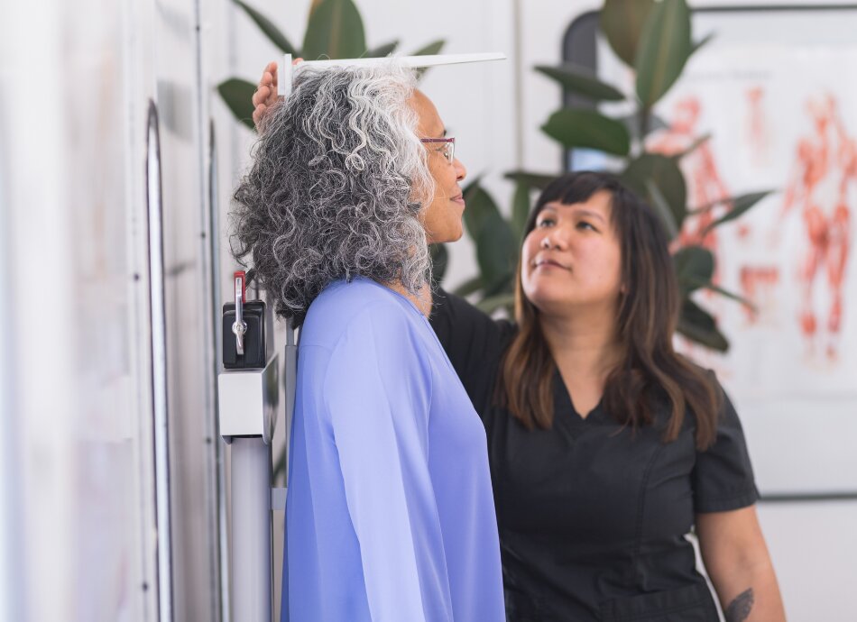 Woman having height measured