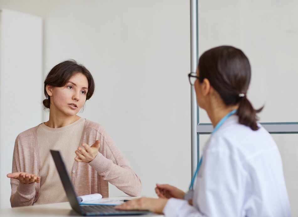 Concerned woman talking to GP