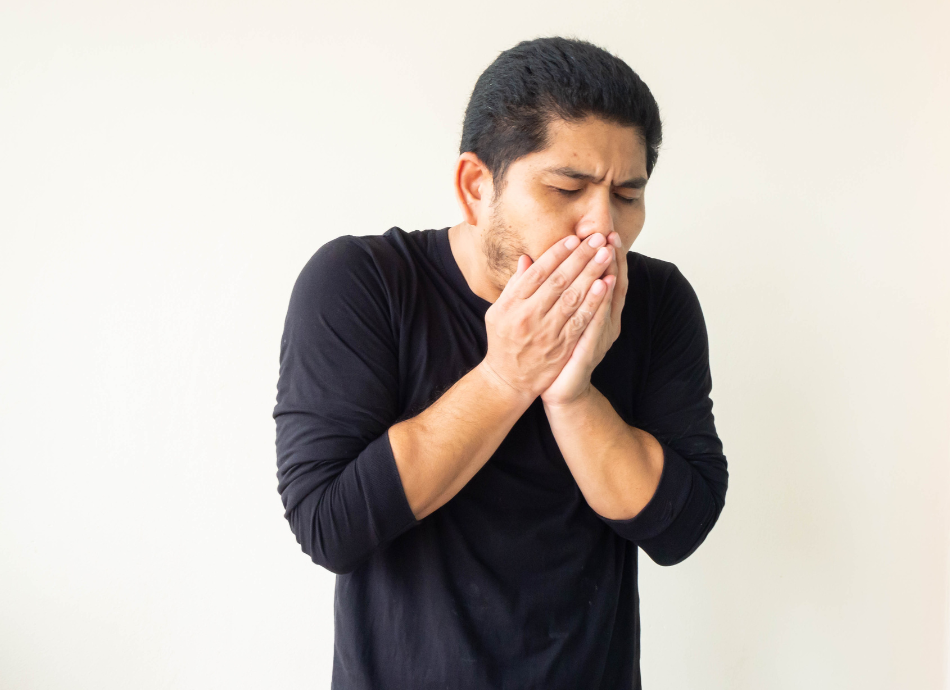 Man coughing into his hands