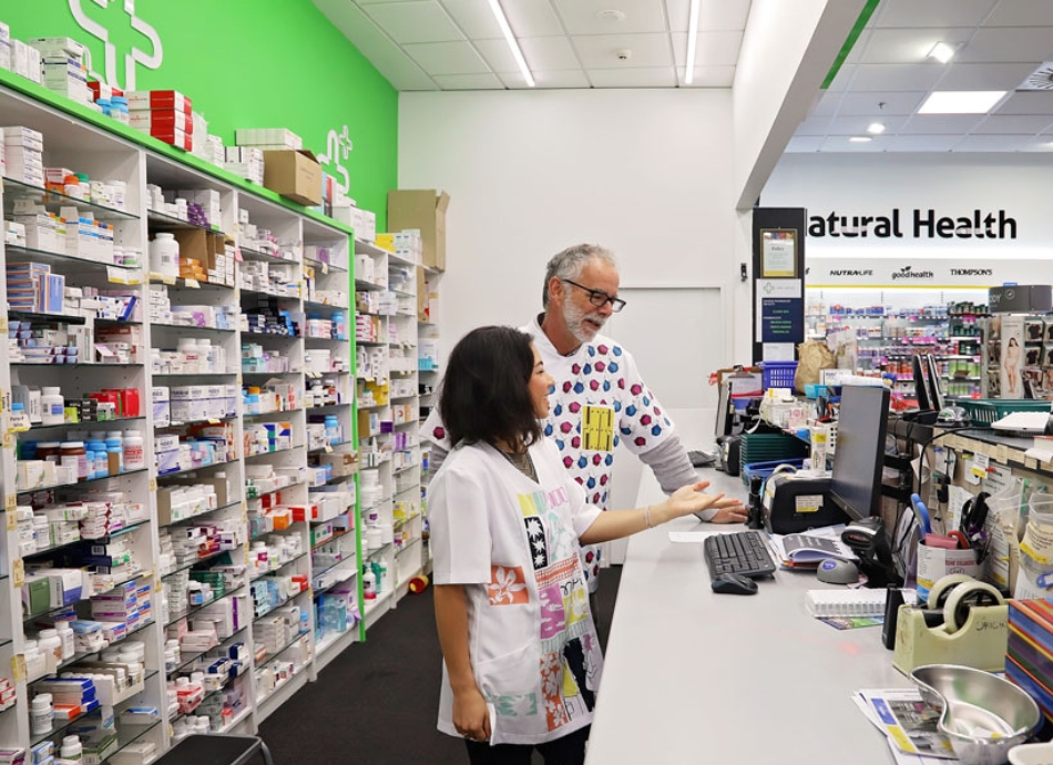 HN 0796 two pharmacists in discussion in dispensary of community pharmacy 950x690