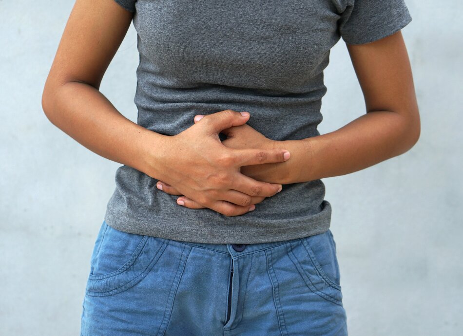 Woman holding abdomen in pain 