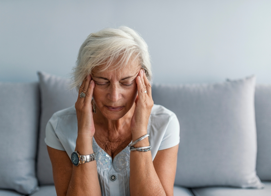 Mid aged woman with headache 