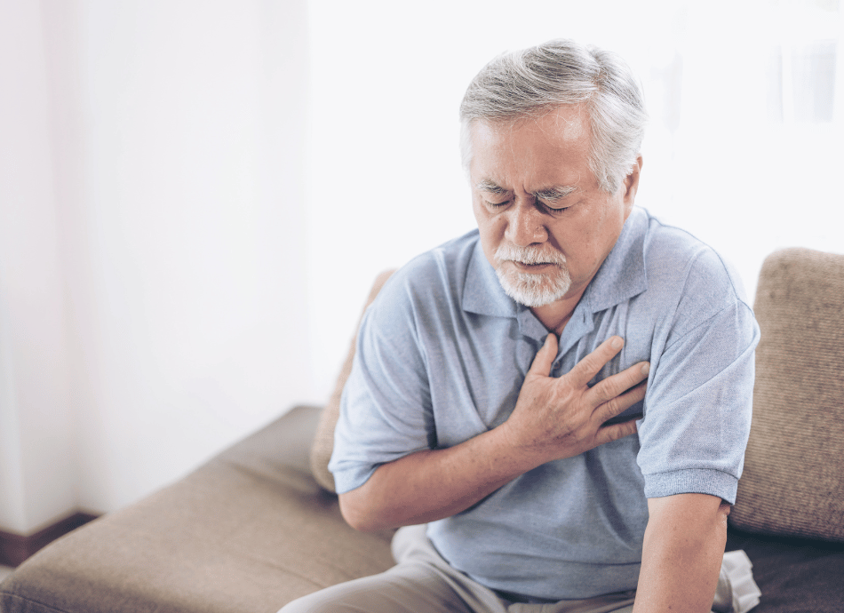 Seated man clutching chest