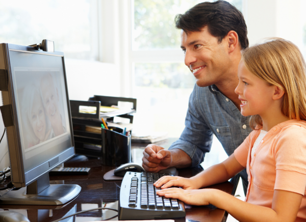 Father and daughter on the computer together