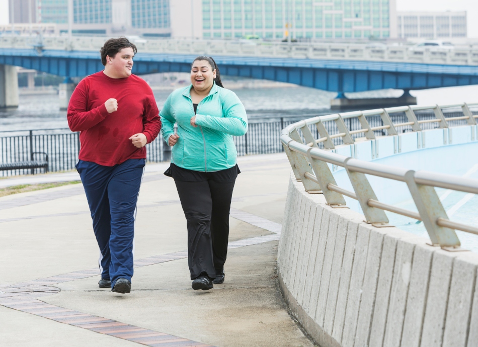 2 larger people power-walking and chatting