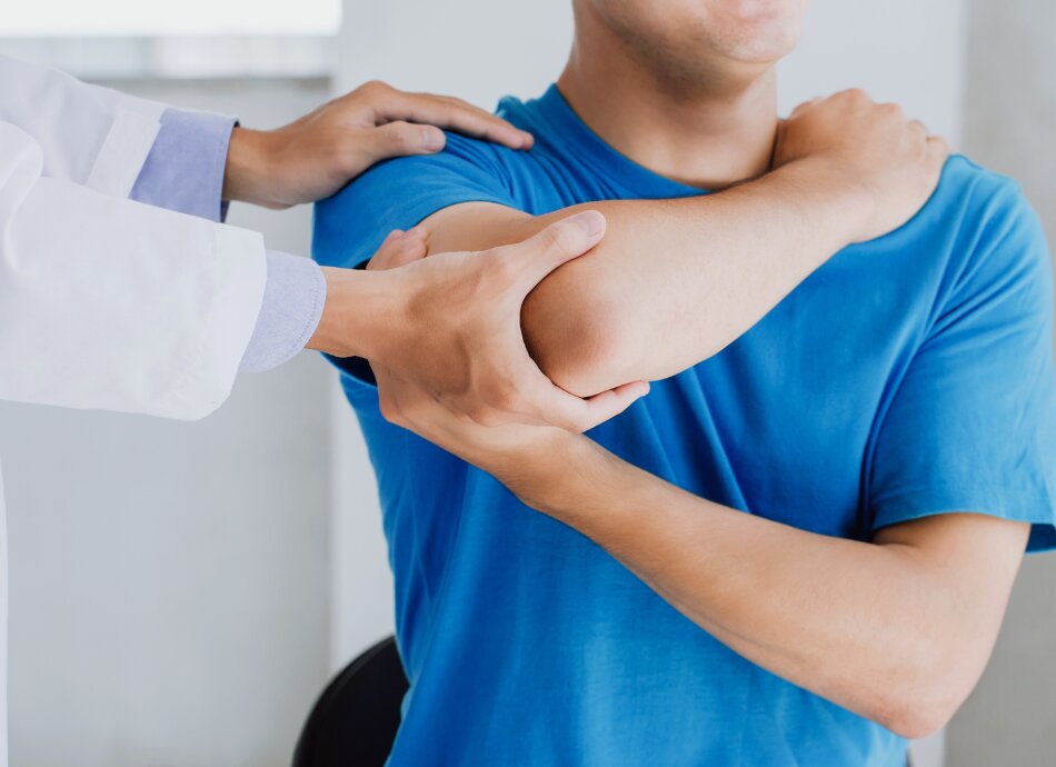 Healthcare professional guides man doing arm exercises 