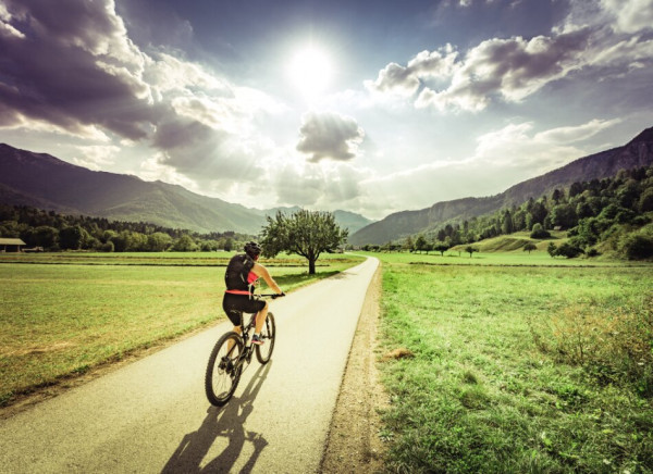 Woman cycling down road