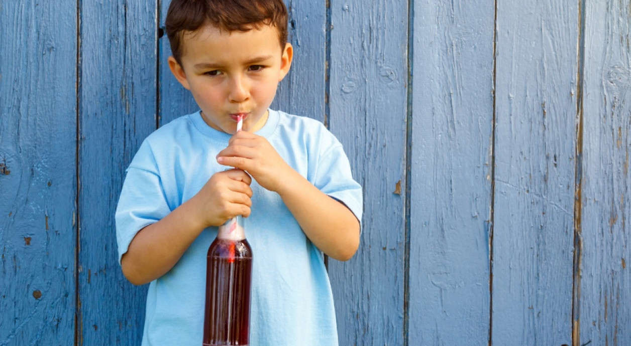 Boy drinking fizzy drink from bottle