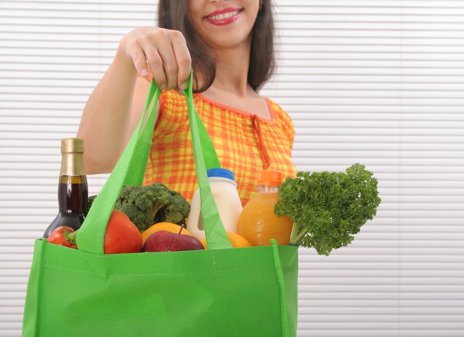 Woman holding reusable shopping bag