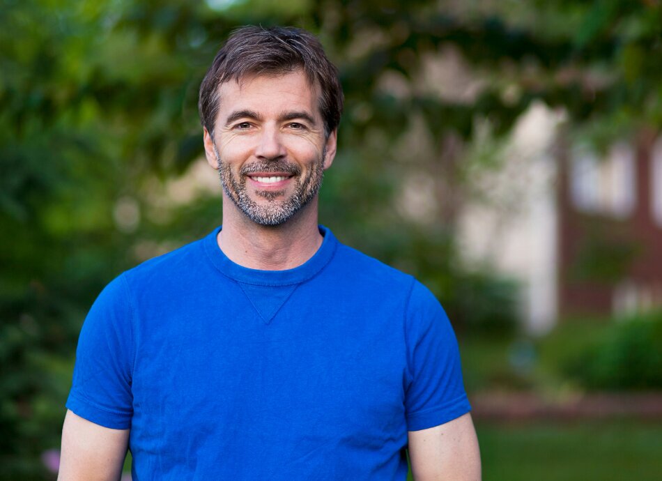 Smiling middle aged man in blue tee-shirt