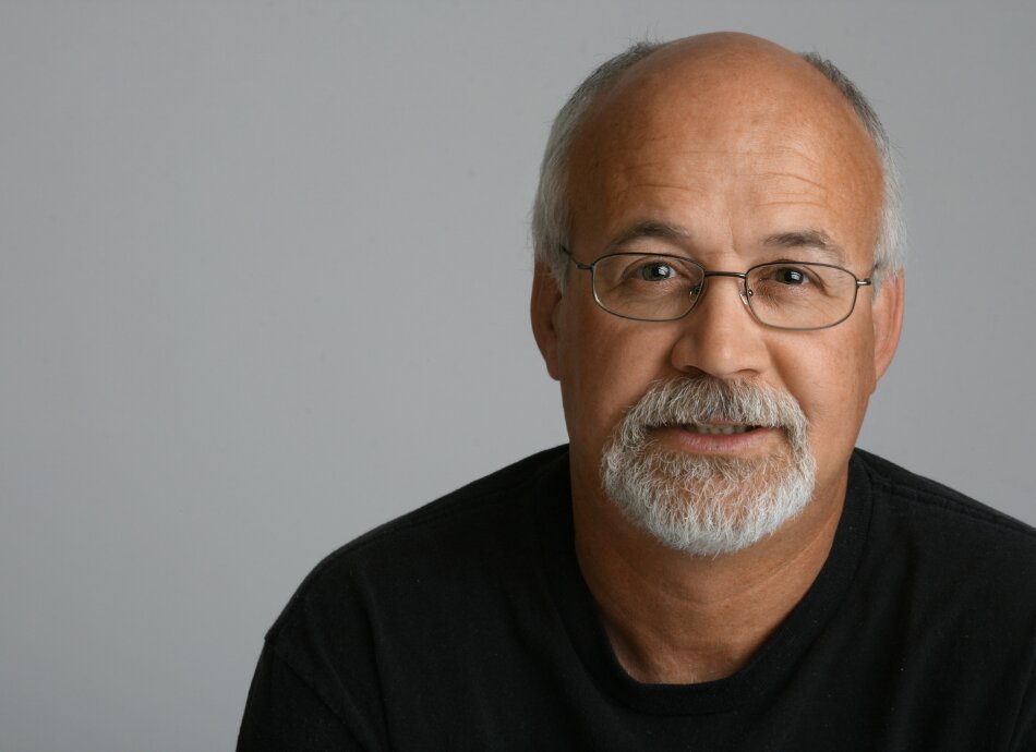 Middle aged man with beard looking at camera