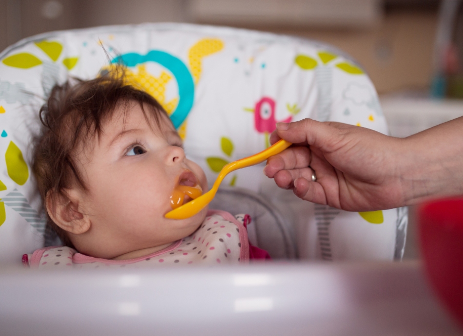 Feeding baby in highchair