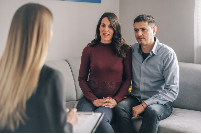 Pregnant couple talking to healthcare provider 