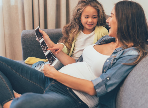 Woman in third trimester with her daughter