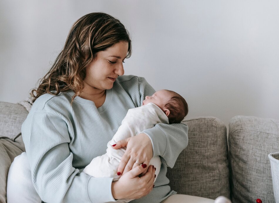 Woman holding small baby canva 950x690