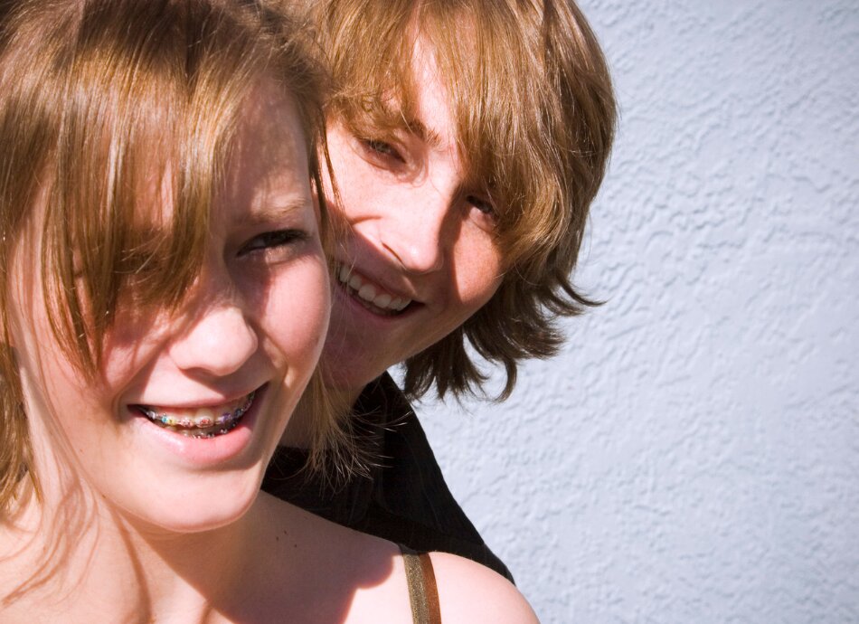 Twins wearing braces on teeth