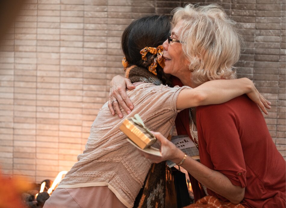 2 women hugging after receiving a gift