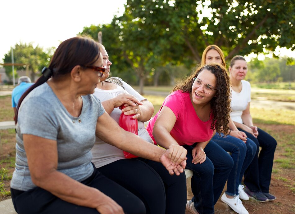 Group of women sitting chatting in the park