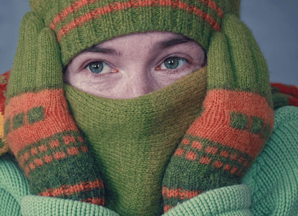 Person wearing hat scarf and gloves