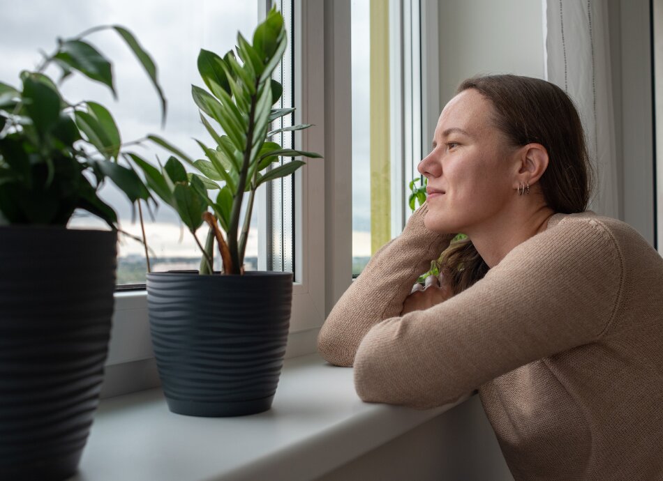 Woman looking out through window 