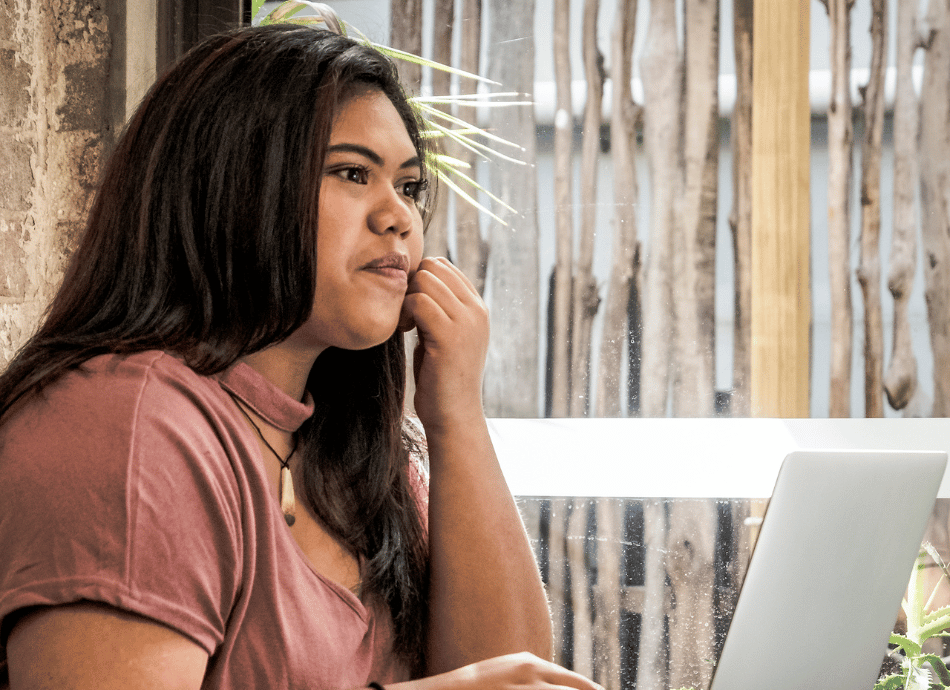 young Pacific woman working on laptop