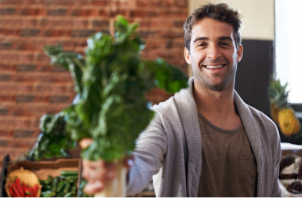 Man holds iron rich green veges