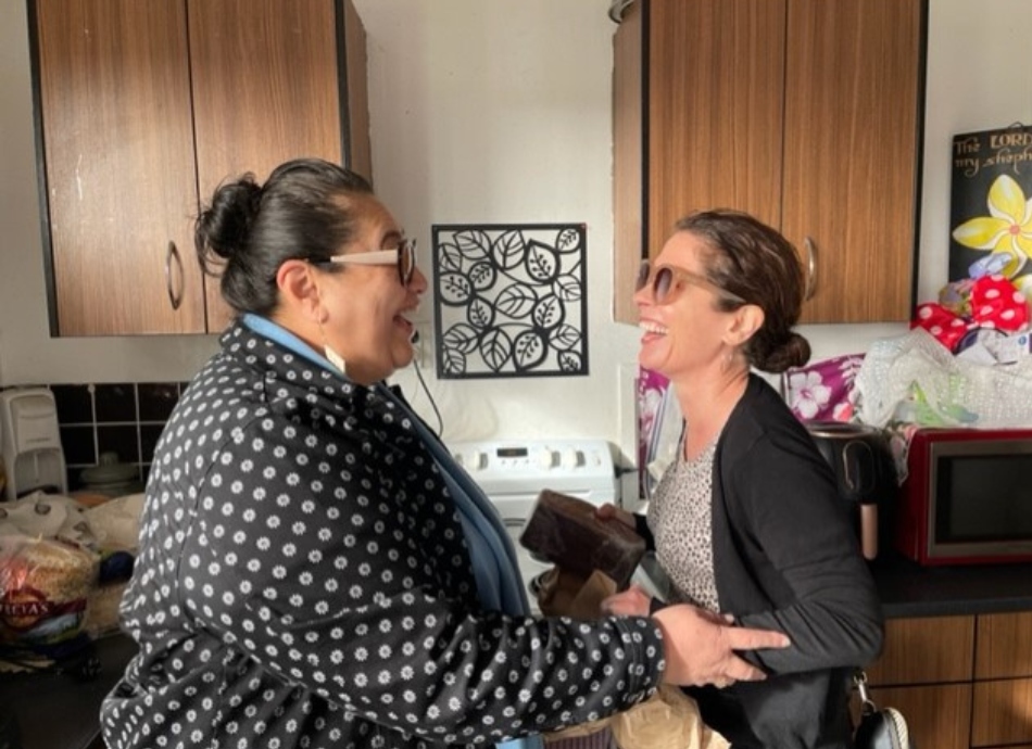 2 women laughing in the kitchen