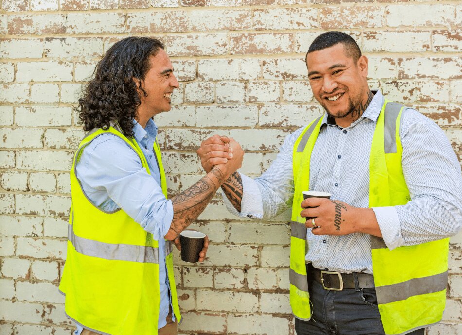 Construction worker friends with high vis jackets 