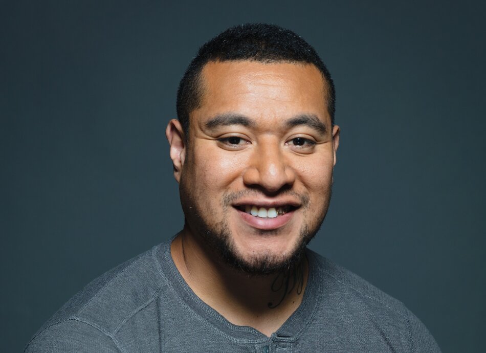 Head and shoulders of Māori man smiling 