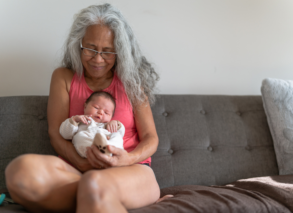 Grandmother cradling newborn baby or mokopuna