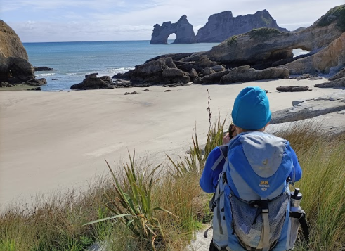 Walker on Wharariki beach New Zealand