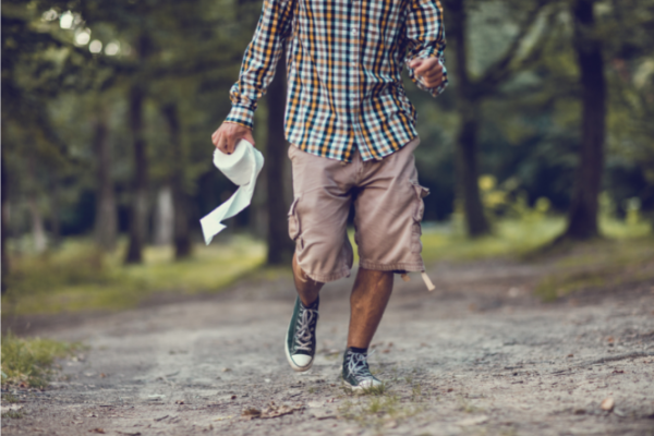 Man running along track with toilet paper in his hand